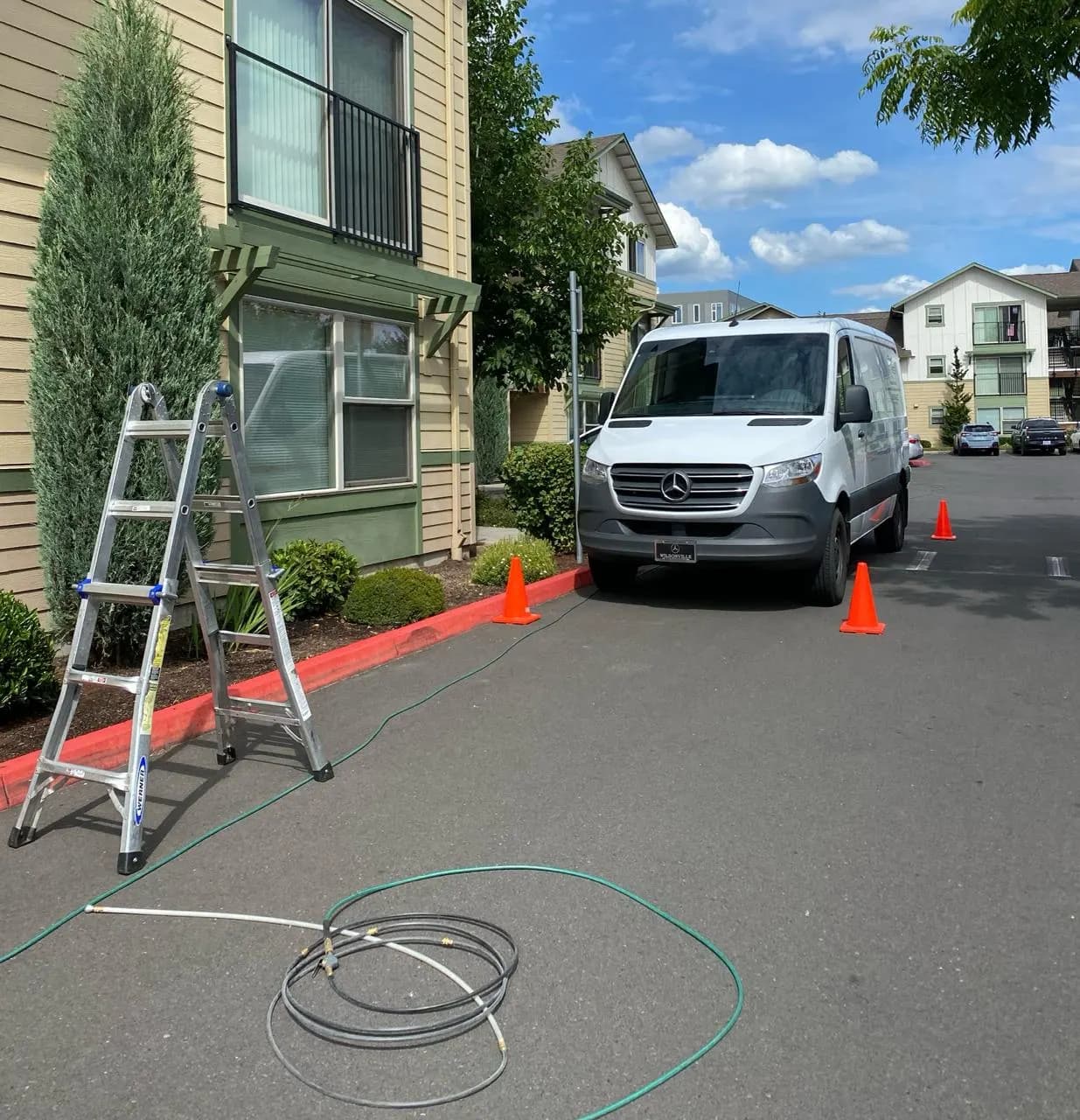 North West Breeze service van parked at a Beaverton apartment complex for dryer vent cleaning